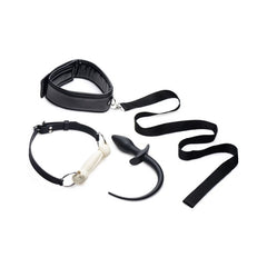 A set of black puppy play accessories including a silicone bone-shaped gag, a flexible silicone tail butt plug, a cushioned adjustable collar, and a leash.
