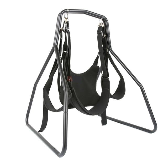A black, low height sex swing with a sturdy frame and a harness made of synthetic leather. It features a deep seat pocket and leg strap support.