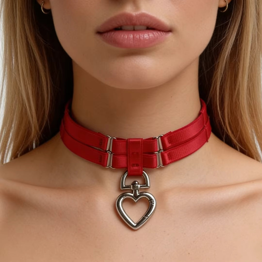 Red choker necklace collar with a heart-shaped leash ring on a BDSM woman