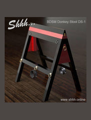 A BDSM apparatus known as the Donkey Stool for sex play & restraint, with adjustable height & various restraint points for ropes and straps
